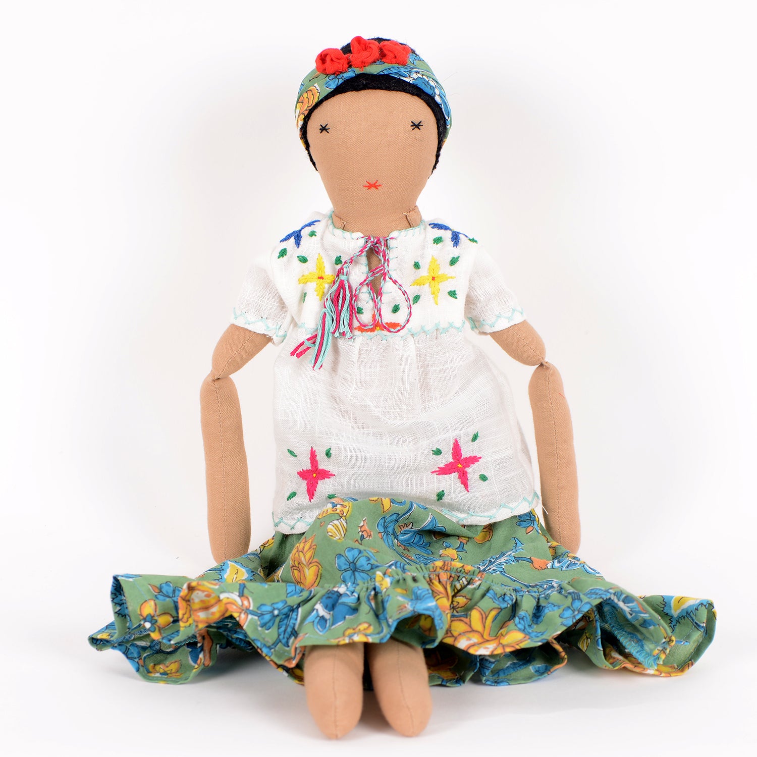 Frida, a handcrafted Afghan doll with vibrant floral patterns and intricate embroidery, symbolizing resilience and empowerment.